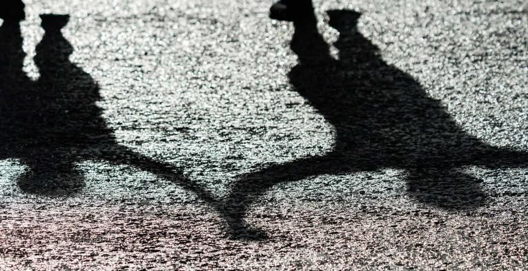 A Shadow of mass runners celebrating as they cross the finish line after completing The 2021 Virgin Money London Marathon