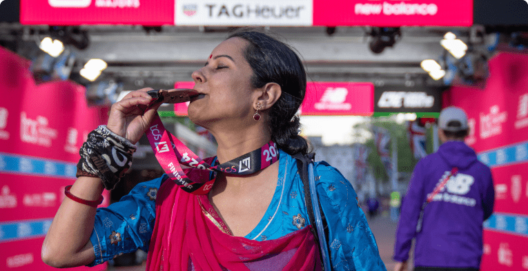 person kissing their medal at the London marathon finish line 