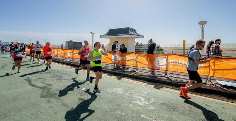 Runners run down a road in Brighton during the marathon