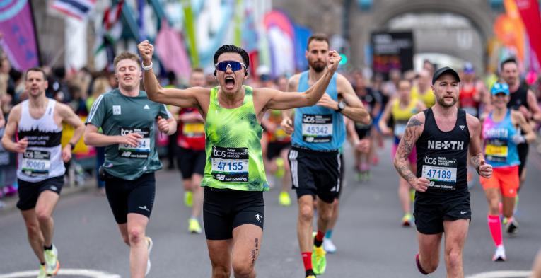 Man running with arms out celebrating