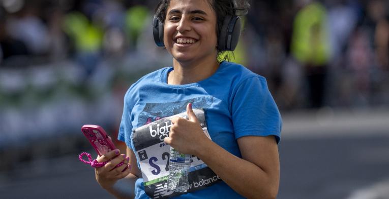 Woman gives a thumbs up as she competes in The big half