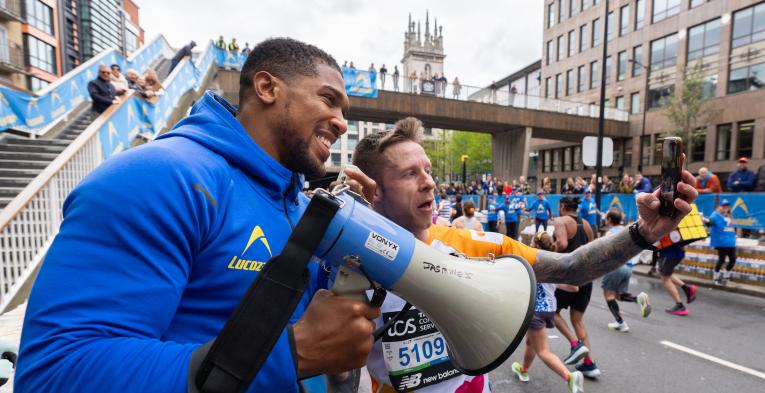 Two people taking a selfie, one has a mega phone in his hand 