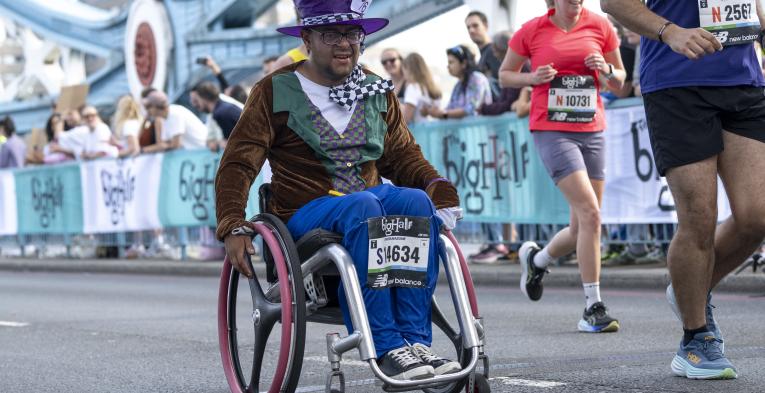 Man in a wheelchair, dressed in a Mad hatter costume participates in The Big Half