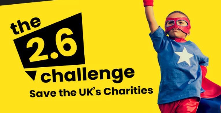 A banner saying "the 2.6 challenge Save the UK's charities" with a kid dressed as a super hero on the right with his fist held high