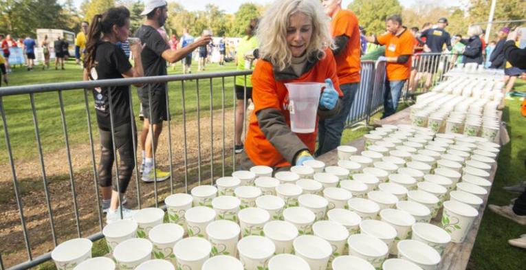 Course marshal filling cups with water.