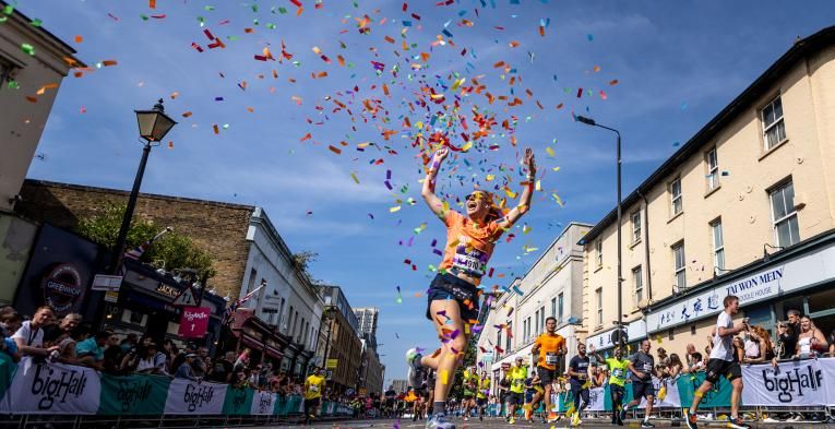 Big Half participant celebrates finishing the event in a cloud of confetti