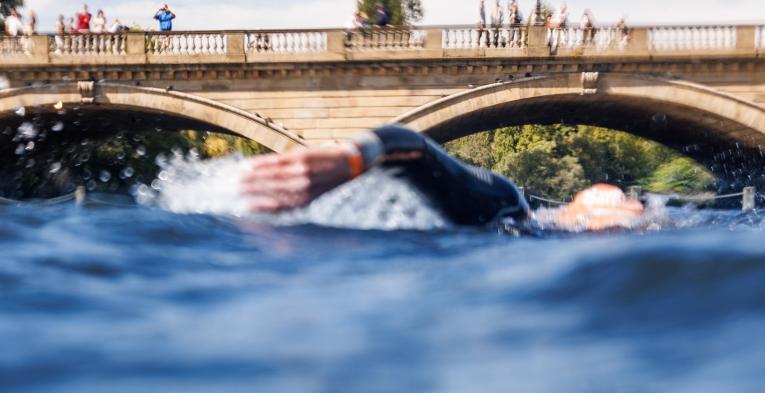 A swimmer emerges from the water during Swim Serpentine