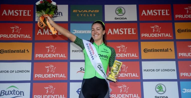 Lady holding up a trophy.