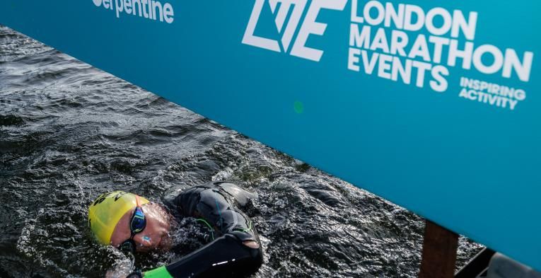 Swimmer passes under Finish Line at Swim Serpentine