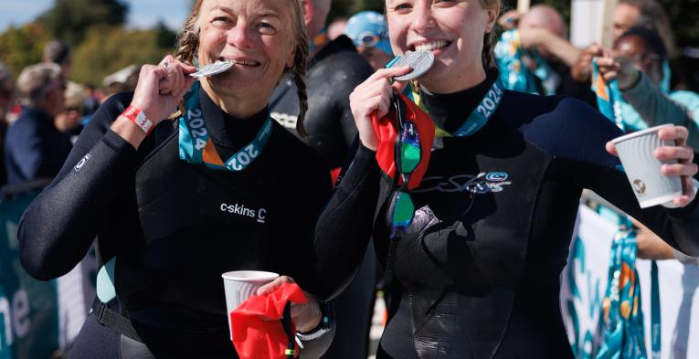 Swimmers celebrate collecting their medals after Swim Serpentine