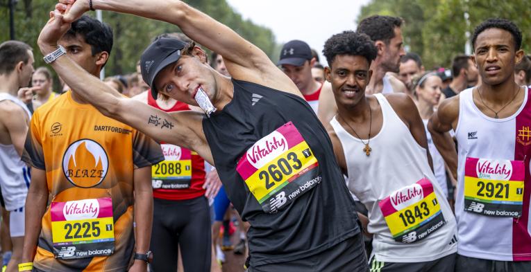 Runners poised at the Start Line, stretching and ready to go 