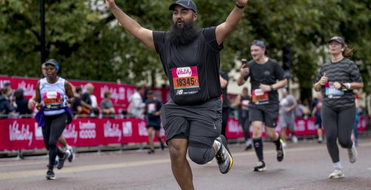 A participant celebrates as he runs along The Mall towards the Finish Line 