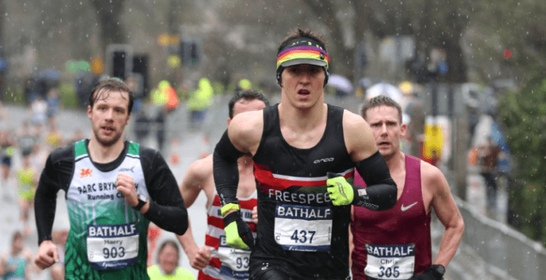 Men running in the light snow.