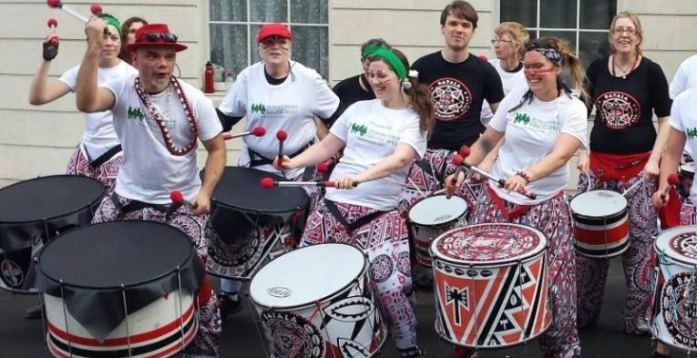 People banging drums on the street