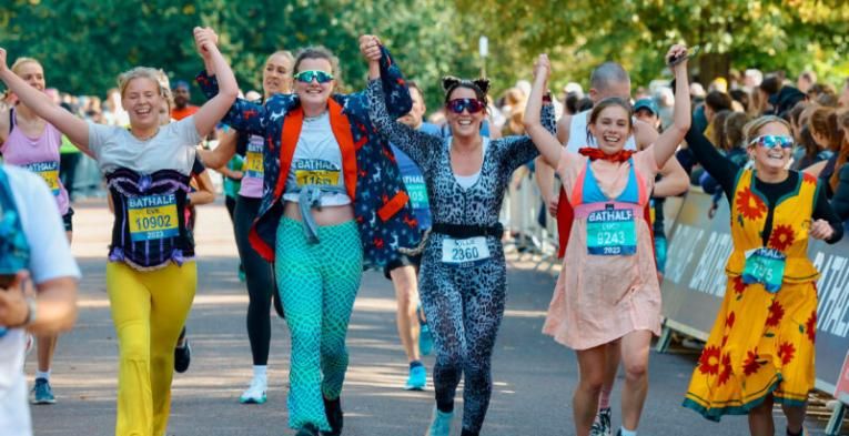 A bunch of people running a marathon dressed in fun outfits.