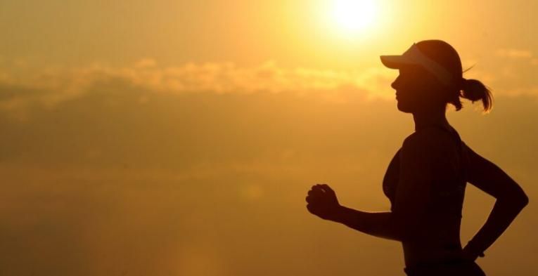 Woman running in the afternoon sunset.