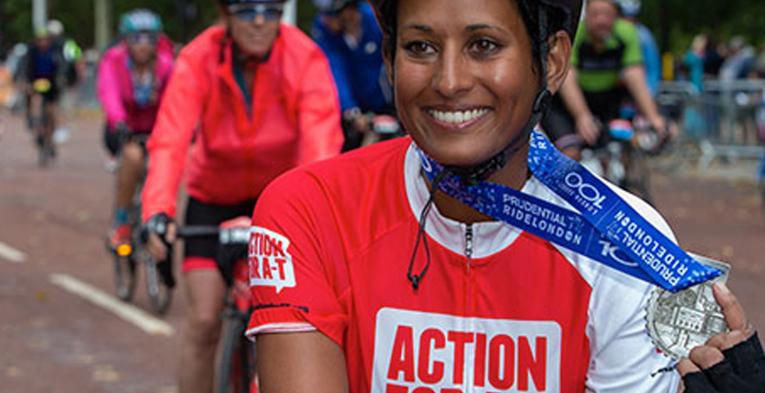 A cyclist smiling.