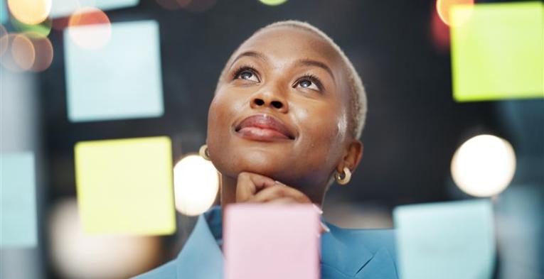 A woman is reading post it notes 