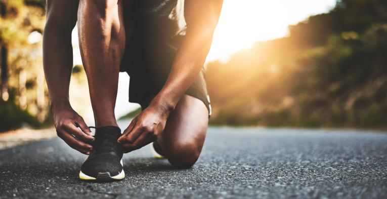 A runner tying up their laces