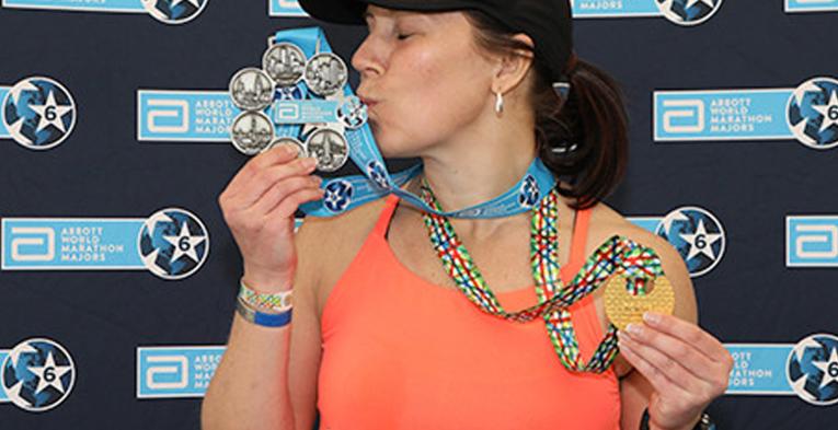 A woman kissing her medal.