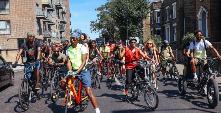 A group of cyclists assembled on bikes