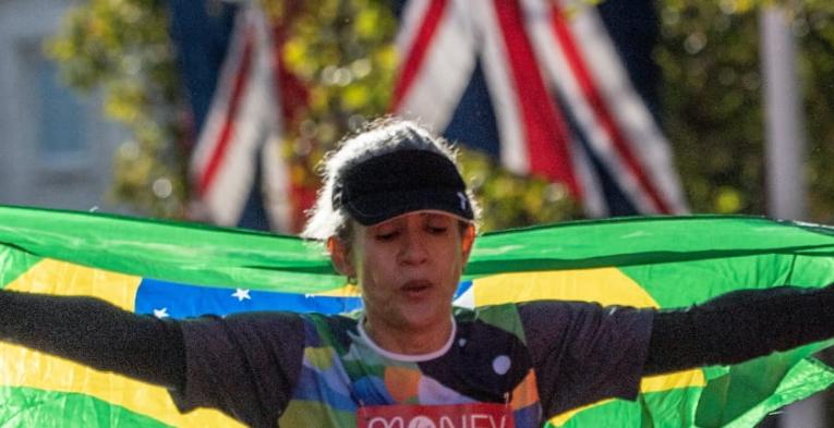 A mass runner crosses the finish line