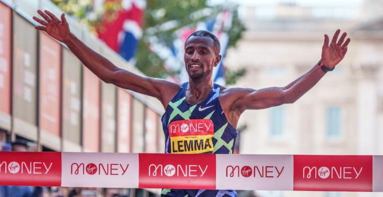 Sisay Lemma (ETH) celebrates as he crosses the finish line to win the Elite Men's Race