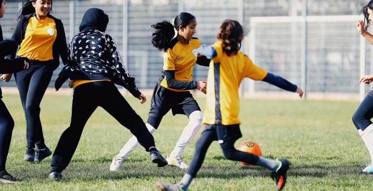 A group of girls playing football