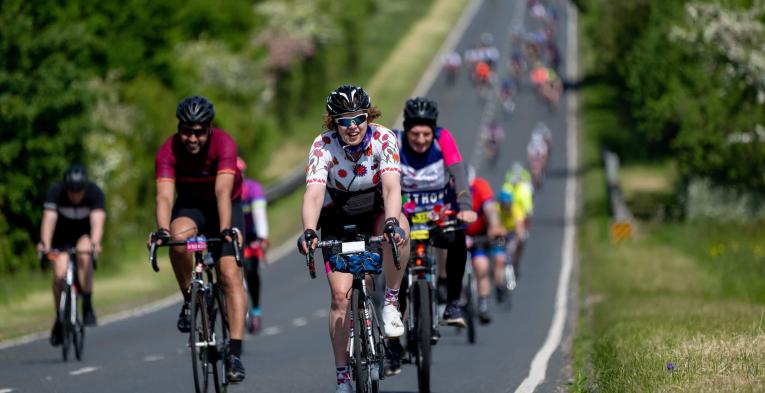 A group of cyclists on a country road