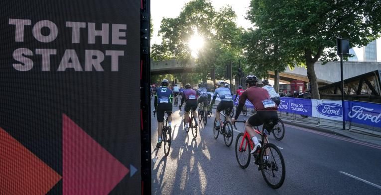 Signage and cyclists at the Ford RideLondon Classique