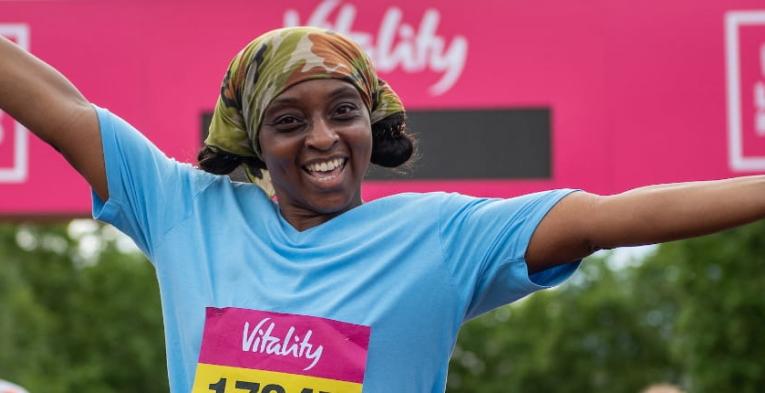 Runners celebrate after crossing the finish line of The Vitality London 10,000