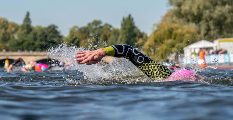 A swimmer submerged, swims through water