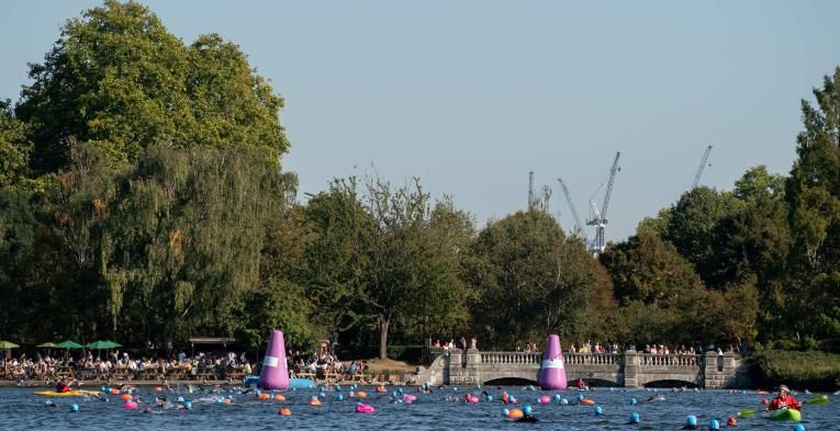 A group of swimmers in the Serpentine lake