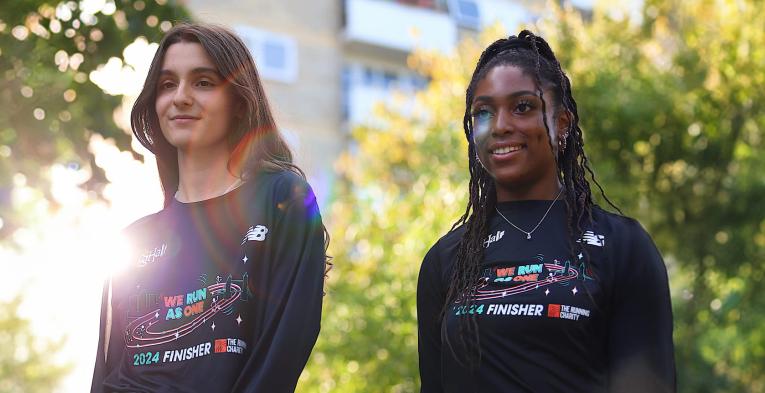 Two women wearing the 2024 The Big Half communities' t-shirt