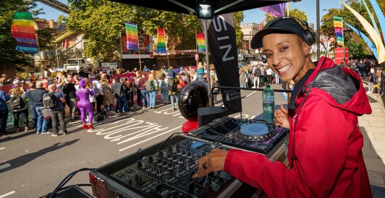 Adele Roberts DJing on stage at Rainbow Row