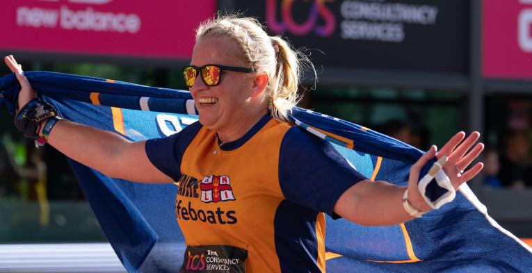 A participant completes the TCS London Marathon for charity