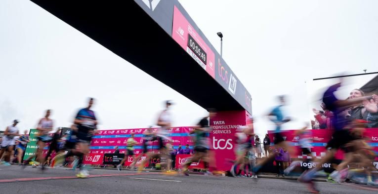 A blur of participants crossing the Start Line