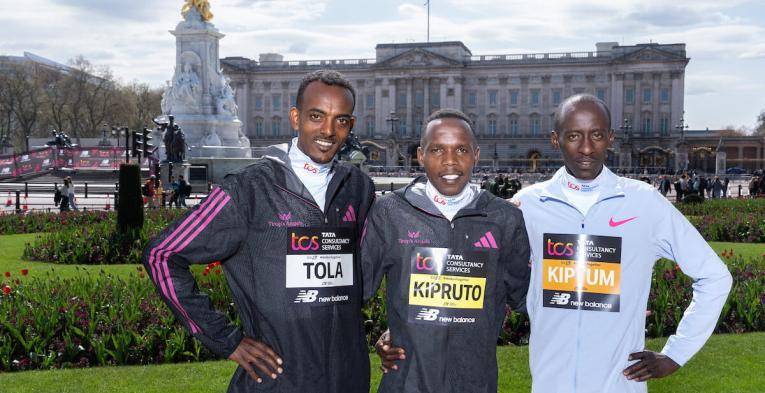 Three elite athletes in front of Buckingham Palace