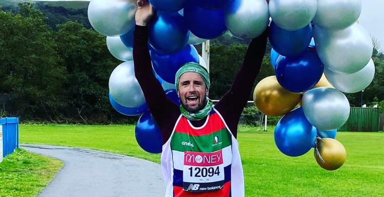 A virtual Virgin Money London Marathon runner celebrates after completing his run