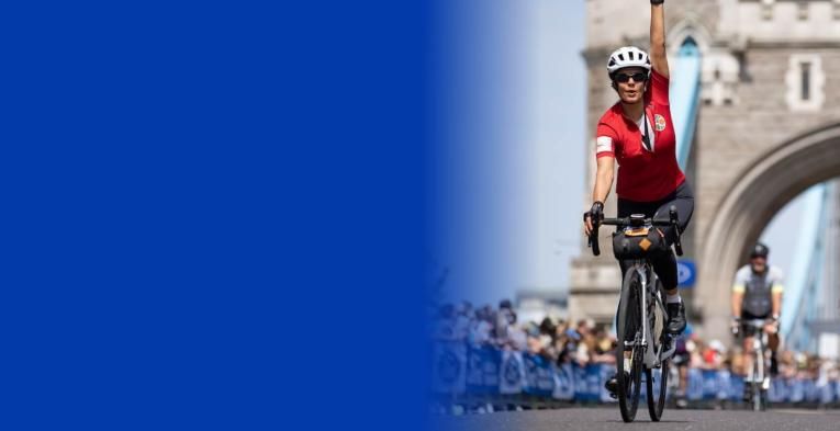 A woman celebrates on Tower Bridge after completing her Ford RideLondon challenge