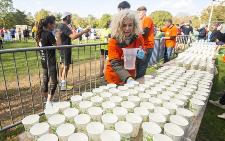 Course marshal filling cups with water.