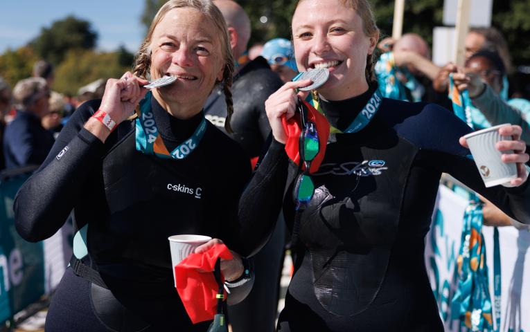 Swimmers celebrate collecting their medals after Swim Serpentine