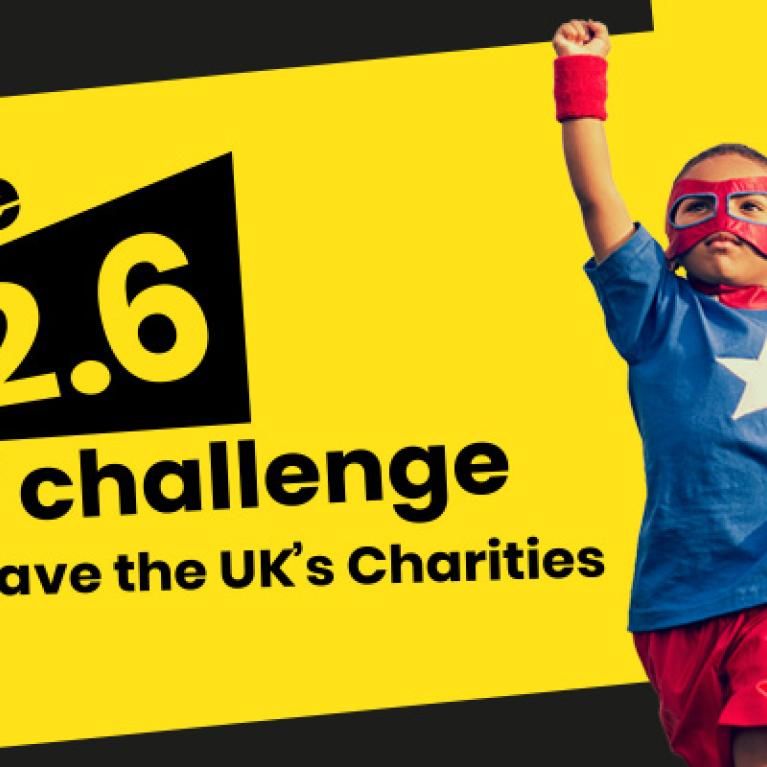 A banner saying "the 2.6 challenge Save the UK's charities" with a kid dressed as a super hero on the right with his fist held high