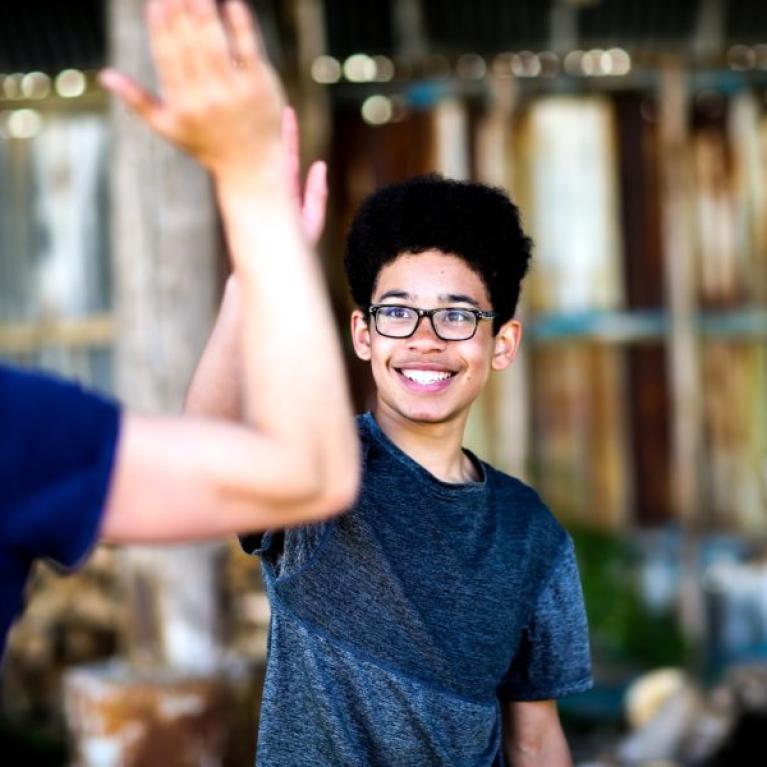 Dudes high-fiving.