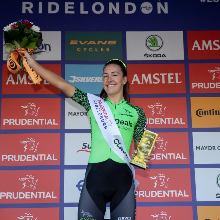 Lady holding up a trophy.