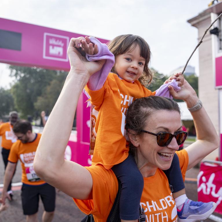 Toddler on shoulders of mum