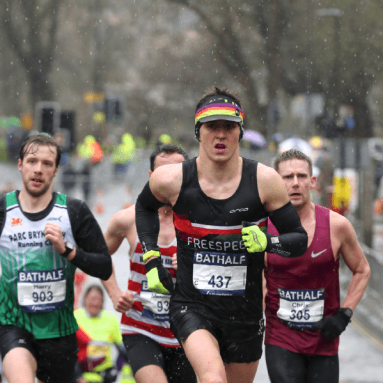 Men running in the light snow.