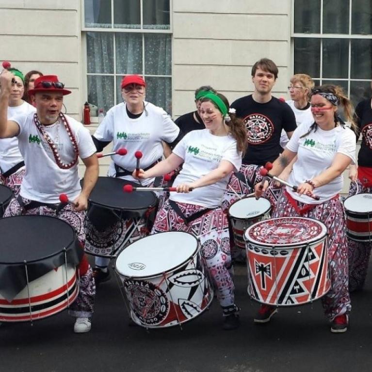 People banging drums on the street