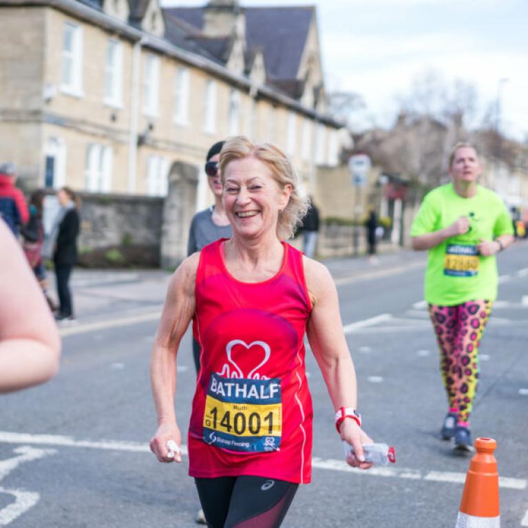 A lady running with a big smile.