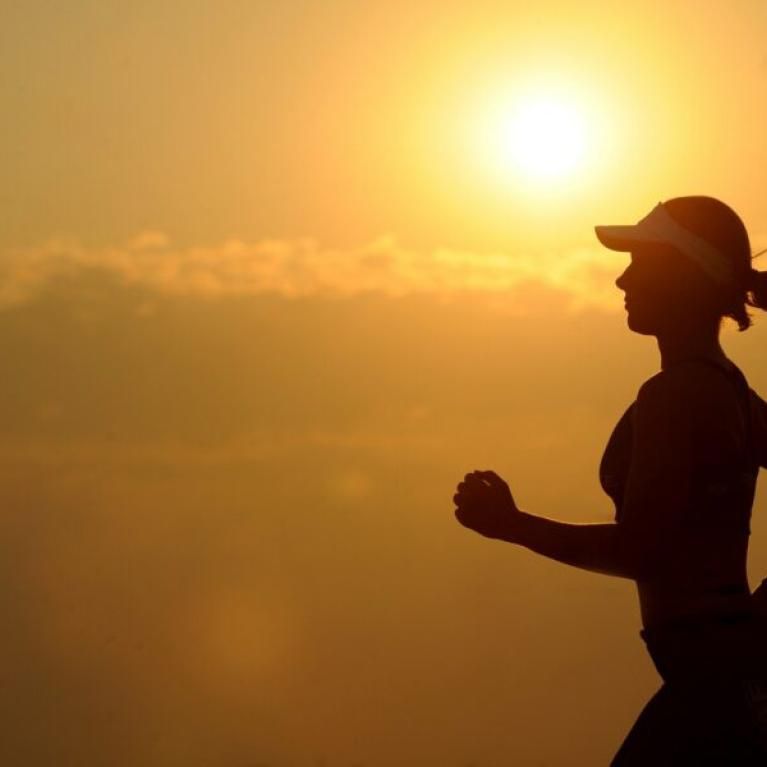 Woman running in the afternoon sunset.